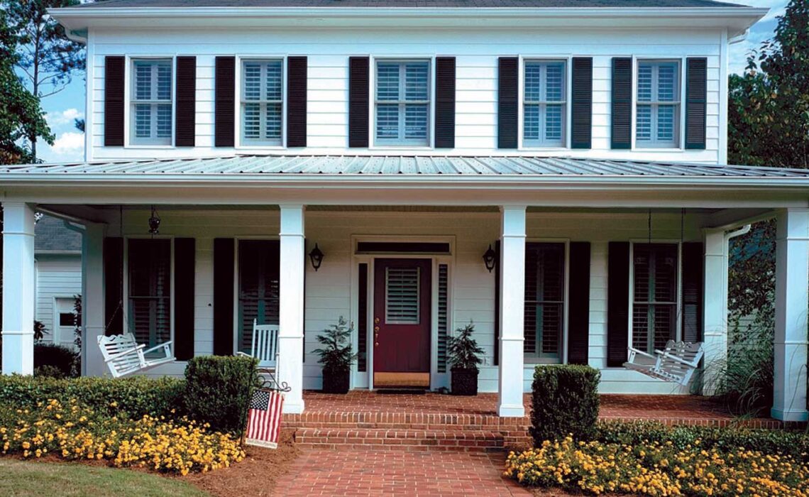 Photo of a residential house exterior with painted hardboard siding