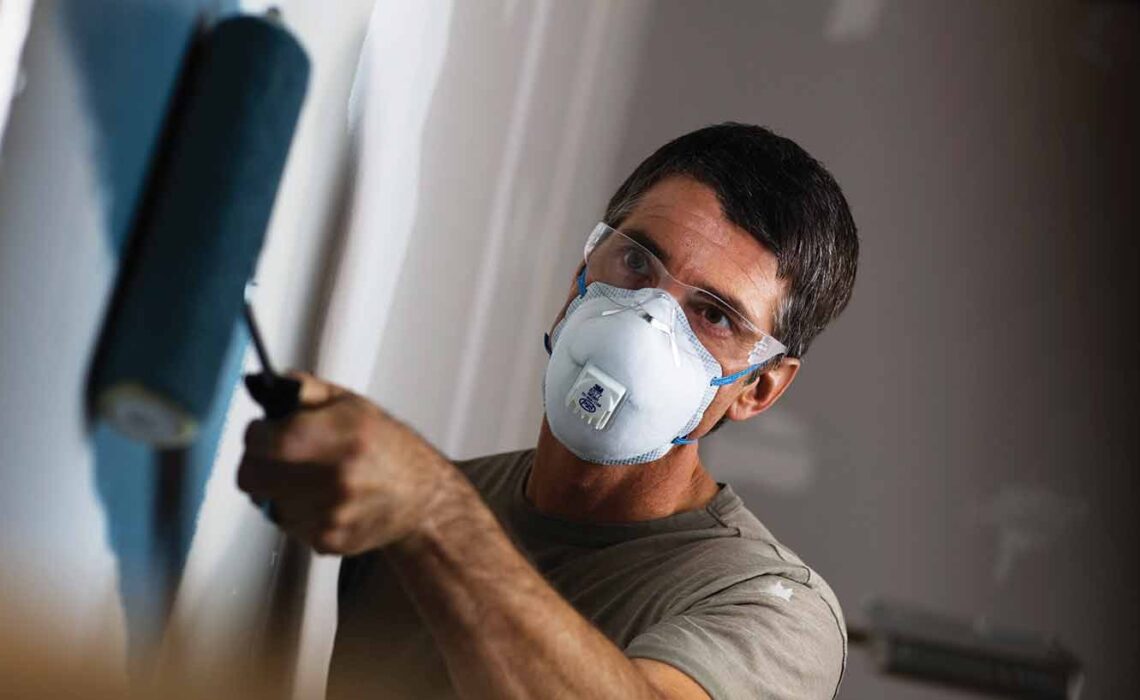 contractor using a disposable particulate respirator with carbon embedded in the filter media