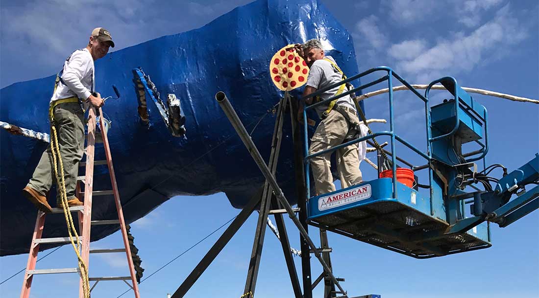 Pros painting the Big Blue Bug in Rhode Island