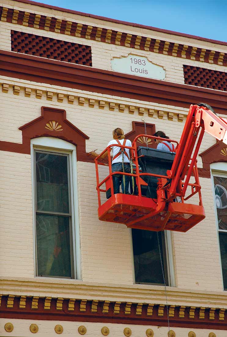 Larson Paint and Stain work from a lift to restore the exterior of the Frederick Rehfuss Building in La Crosse, Wis.