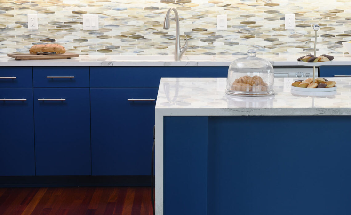a kitchen remodel featuring bold blue painted cabinetry