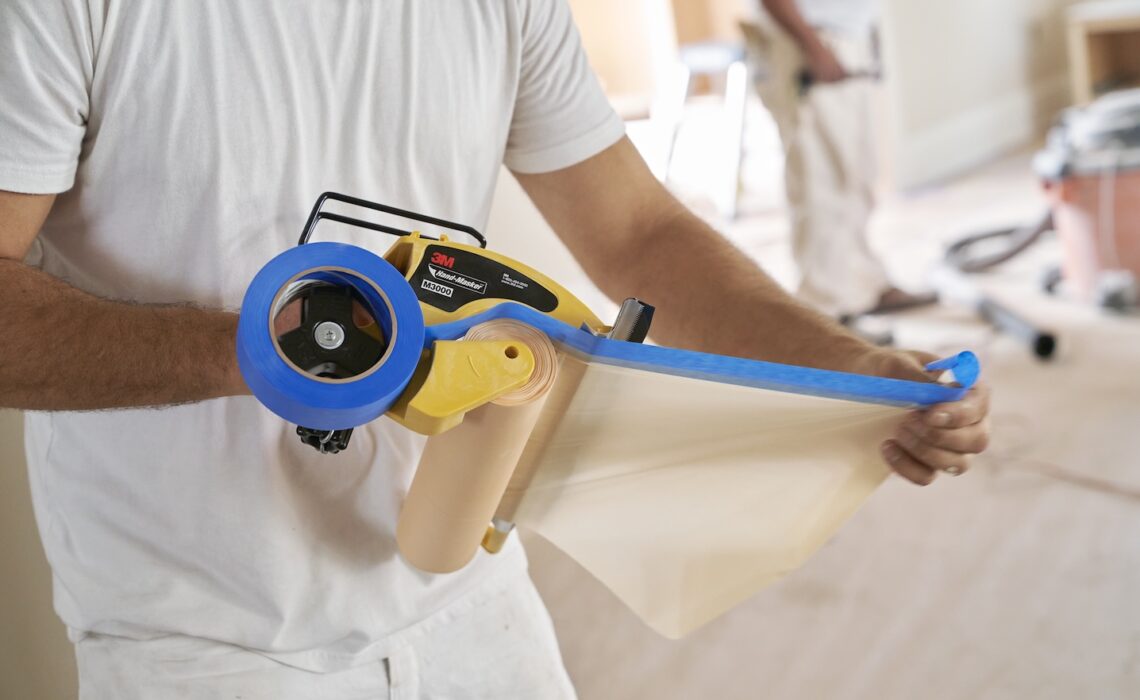 Paint pro uses 3M Hand-Masker on job site