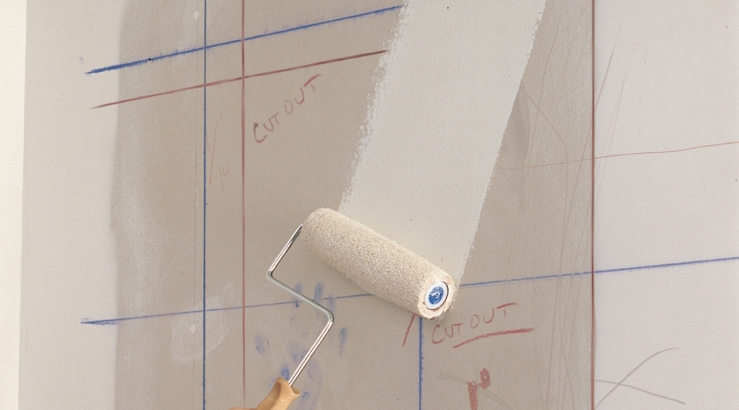 Using a roller and primer to cover marks on a wall