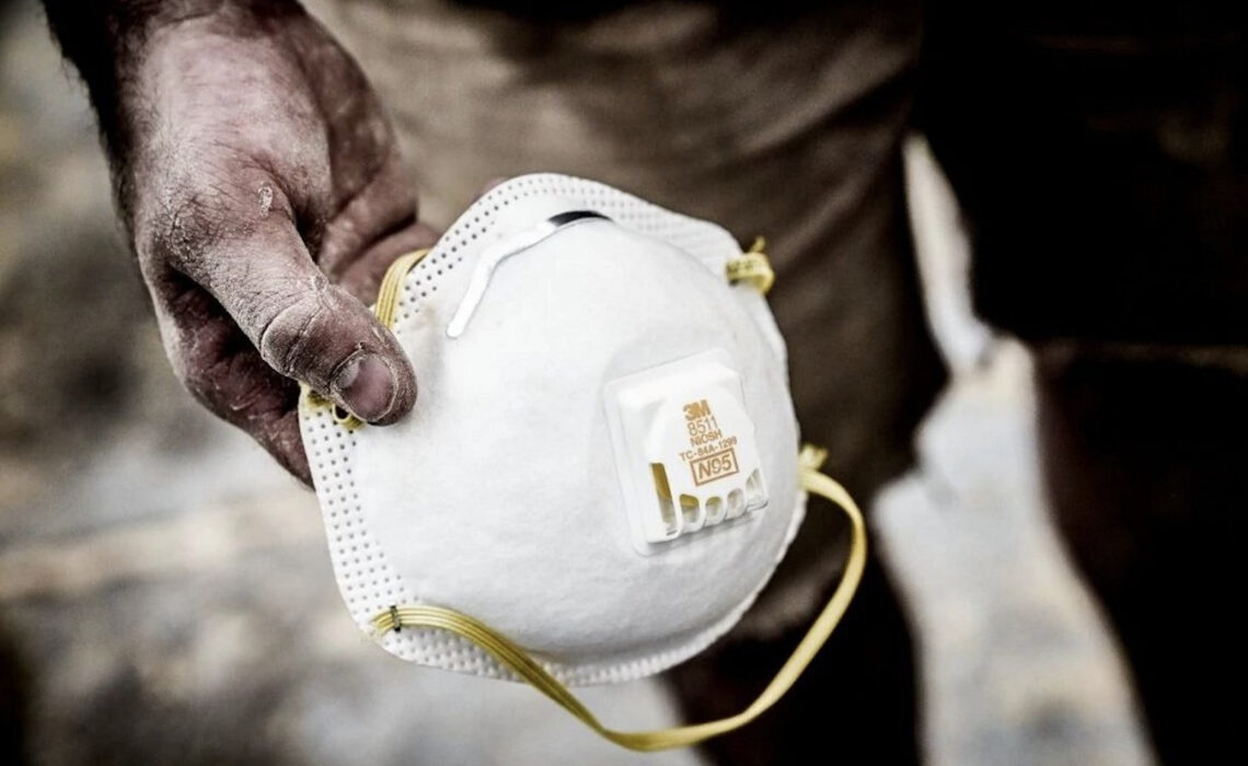 Pro painter holding 3M 8511 respirator