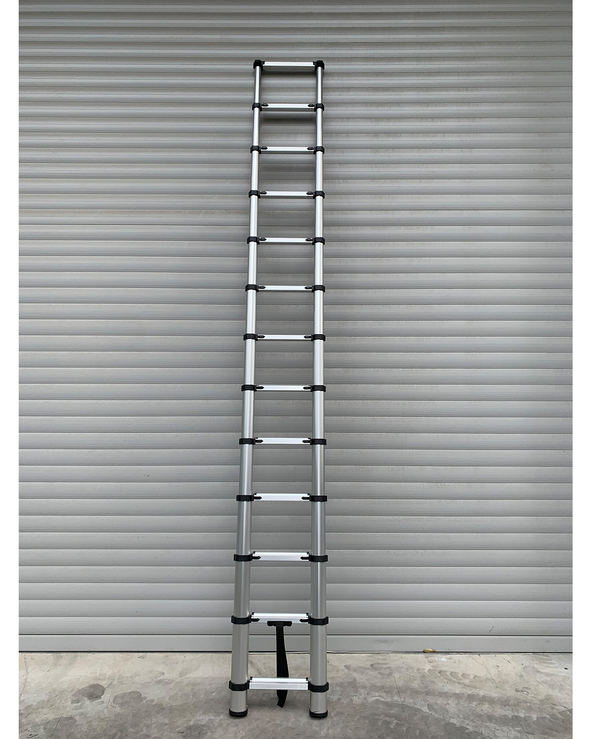 Austrum Telescoping Ladder extended to full length on job site