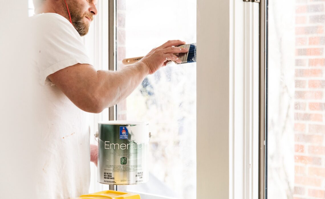 Paint pro applying Emerald Trim Enamel paint
