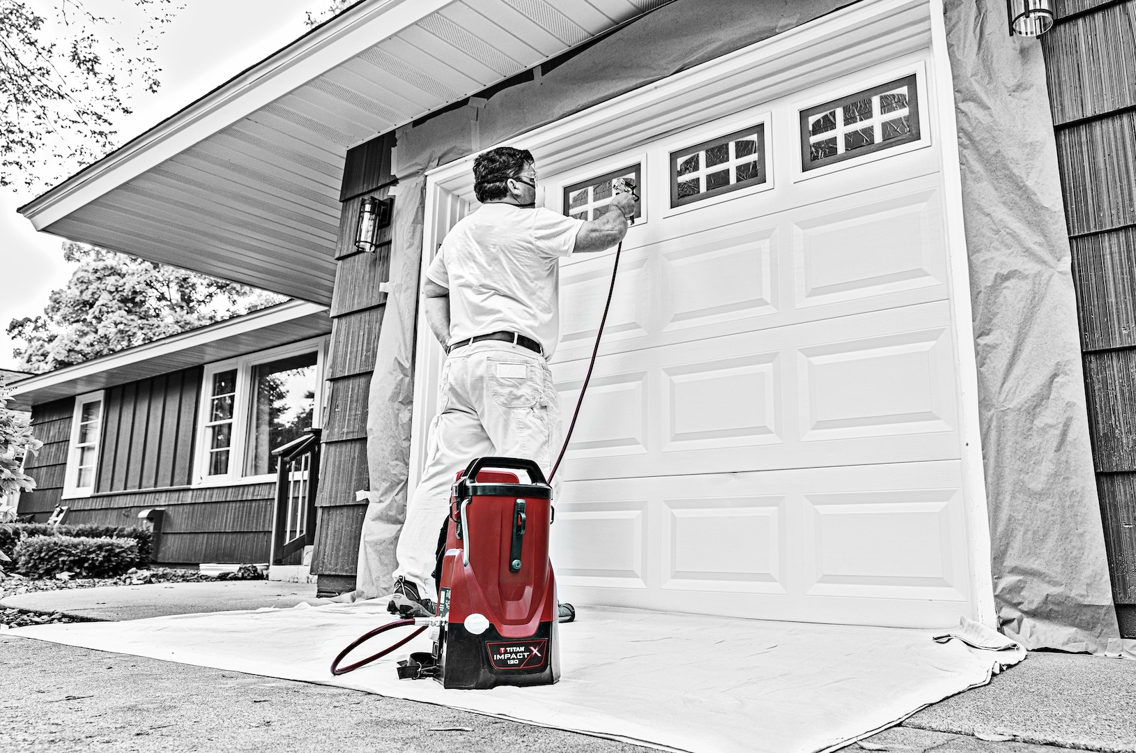 Paint pro uses Titan Impact X 120 18V Sprayer on garage